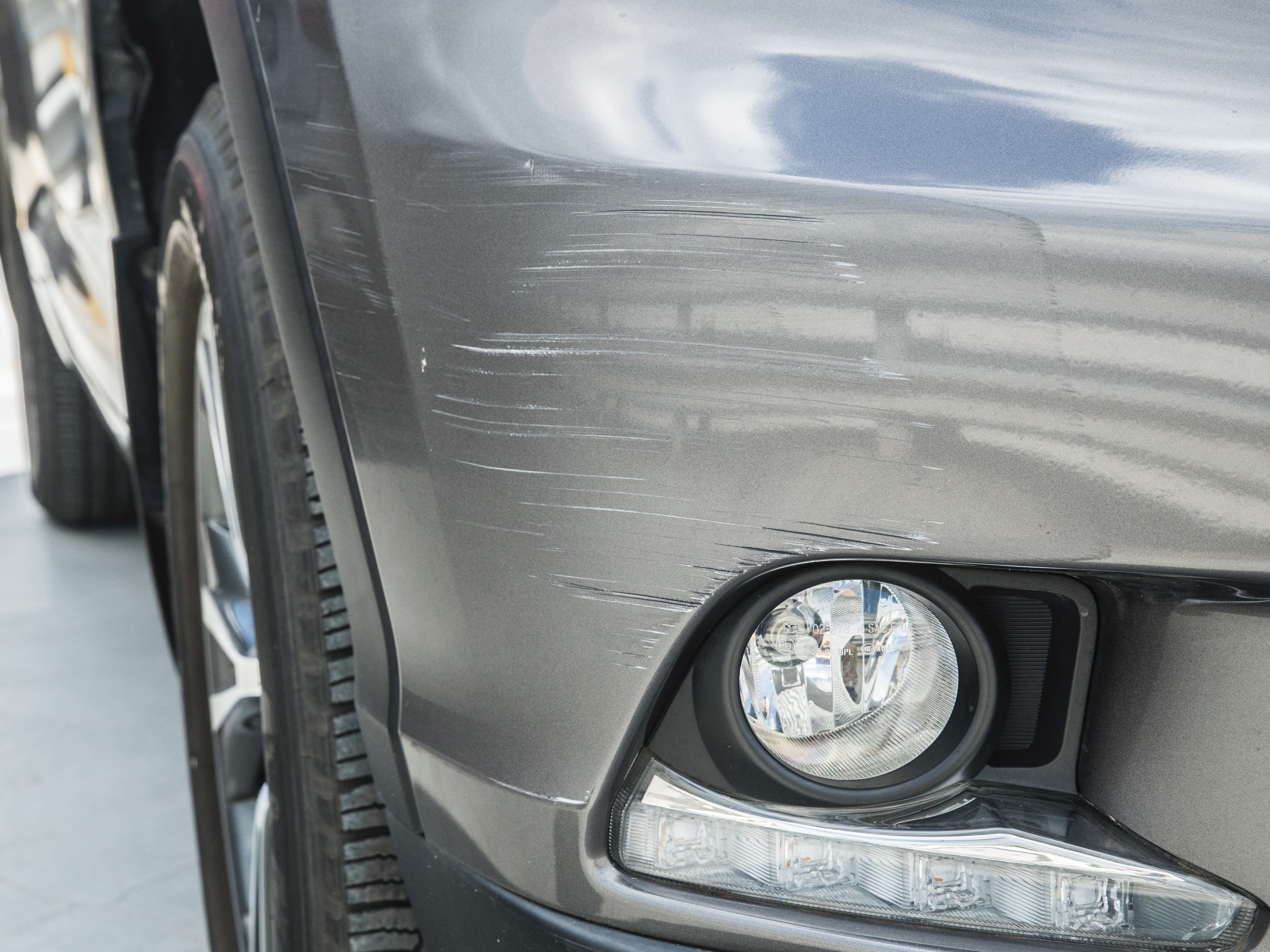Scratches on a car bumper near the fog light