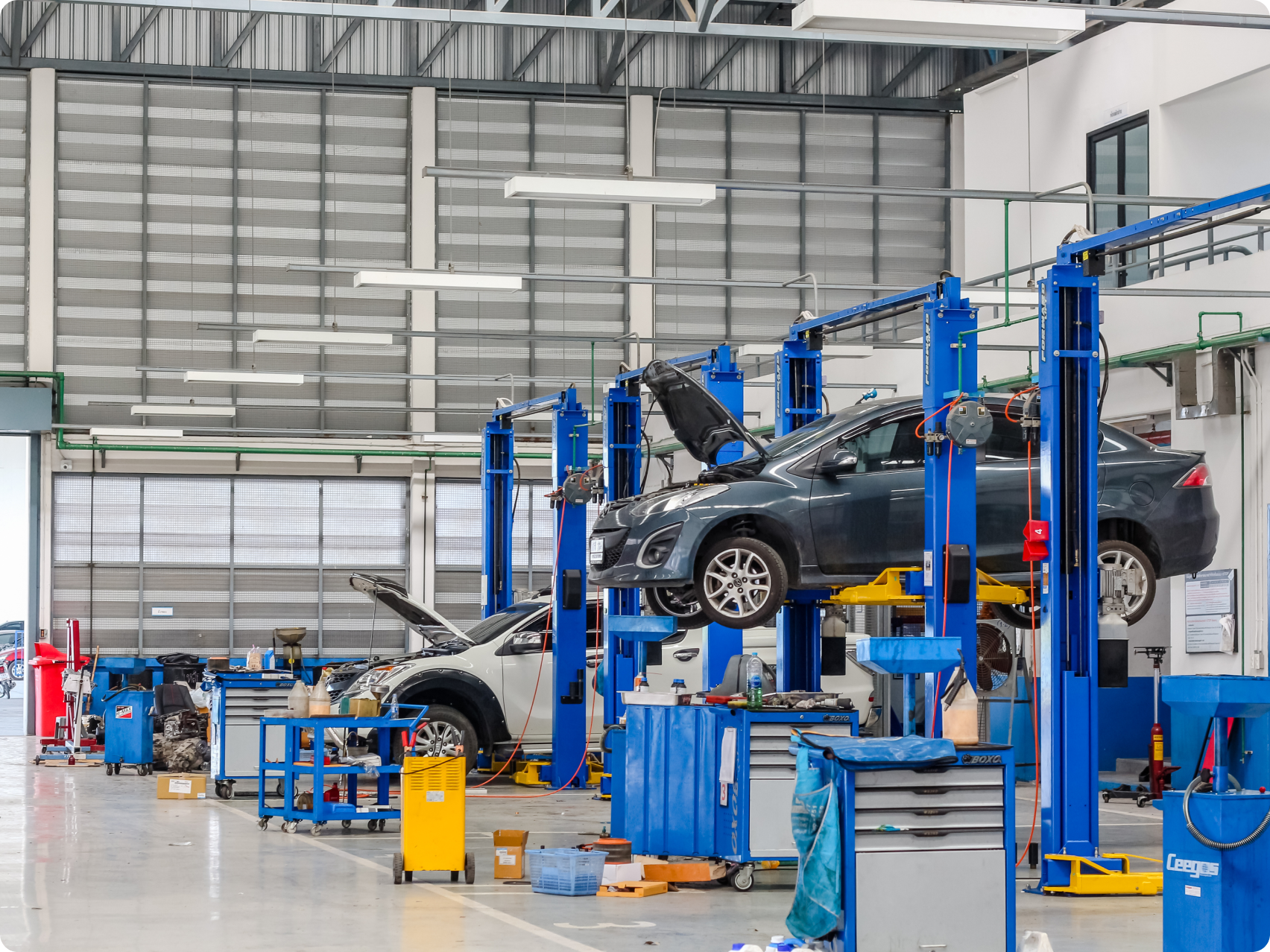 Cars being lifted in a mechanic 