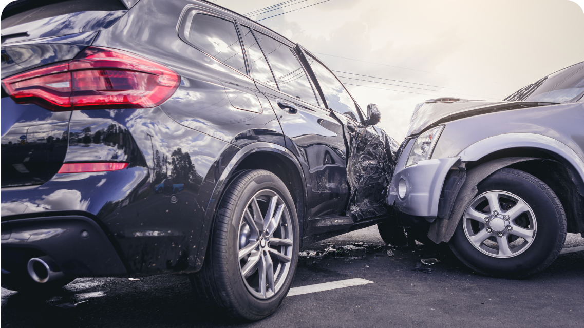 Damaged black and silver SUVs after collision on road